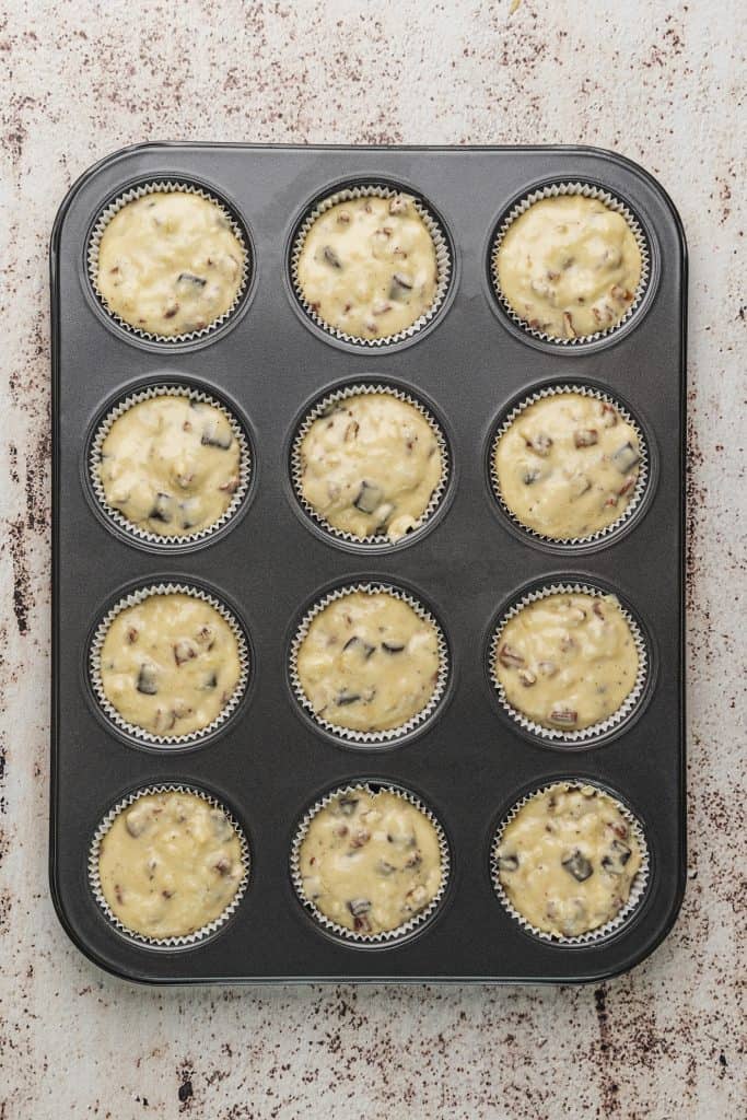 banana chocolate chip muffins in muffin Tins ready to bake