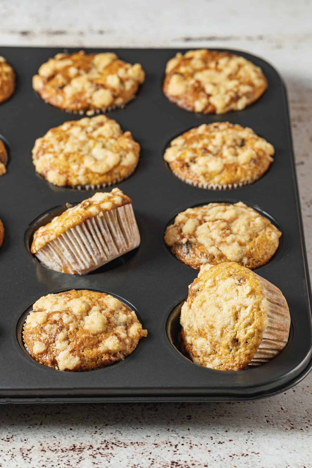 banana chocolate pecan muffins with streusel topping in baking pans