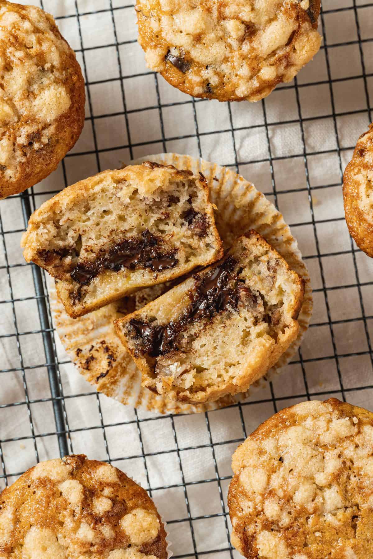 banana chocolate chip muffin cut in half on cooling rack
