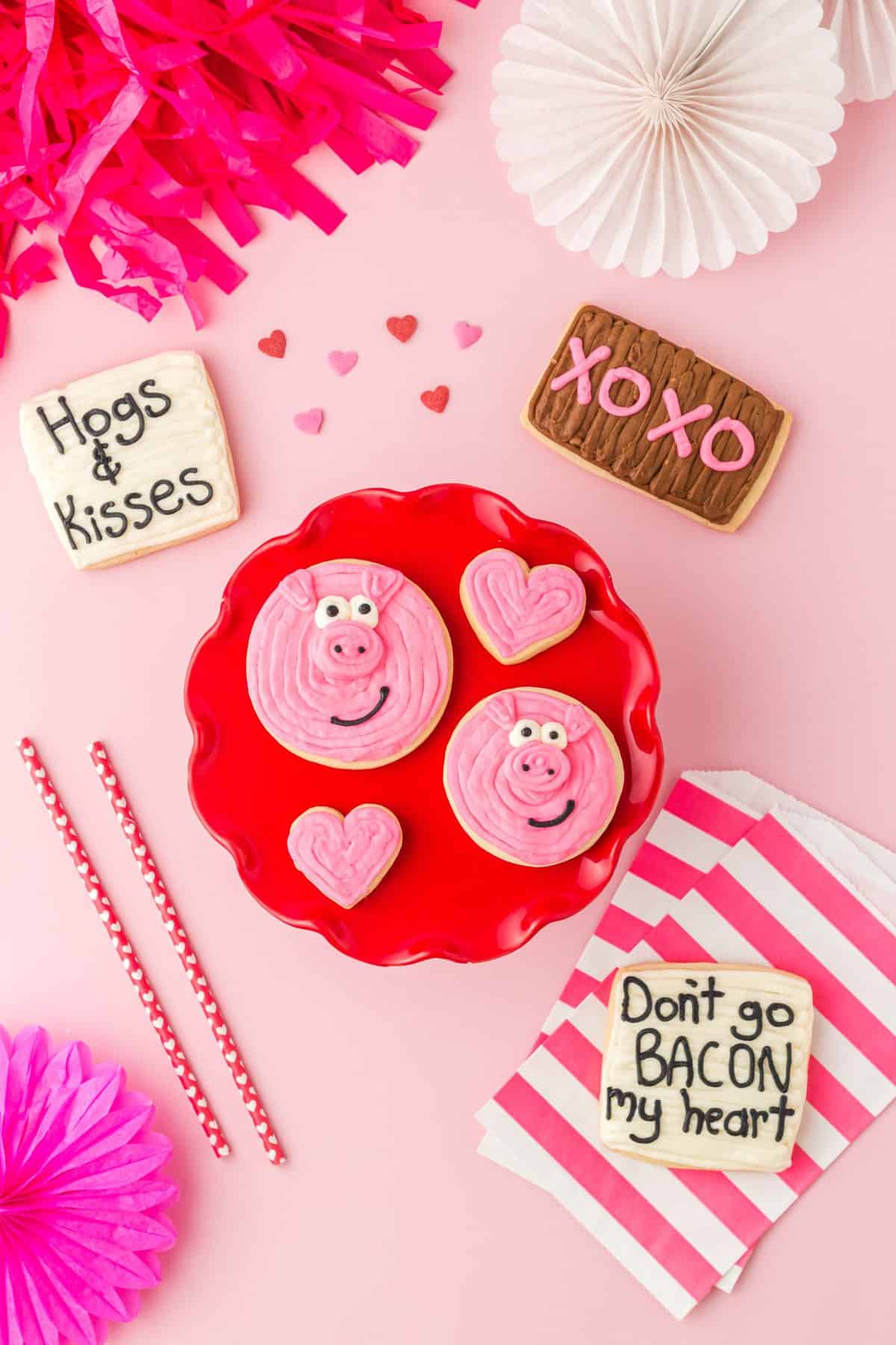 red cake plate with valentines day pig sugar cookies