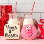 pig sugar cookies with jars of milk in the background