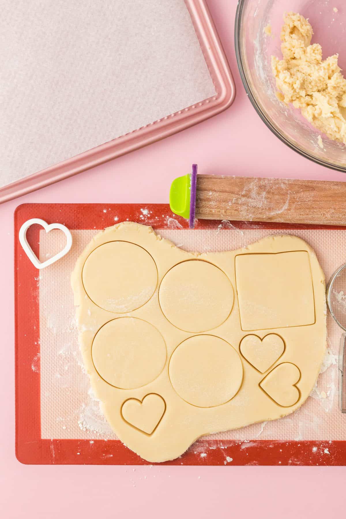 cutting out the sugar cookie dough on silpat surface