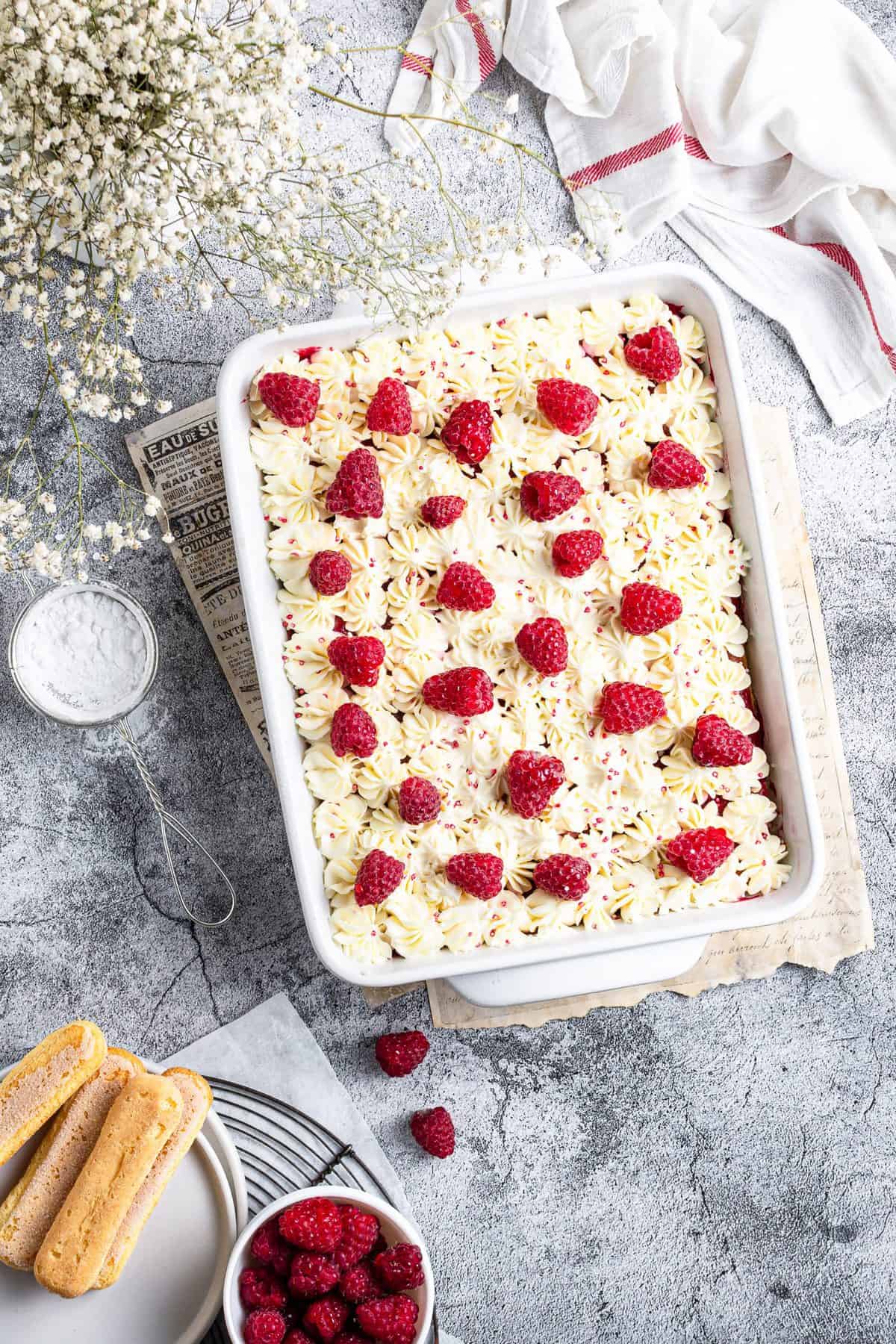 whole white dish with raspberry amaretto tiramisu studded with fresh raspberries