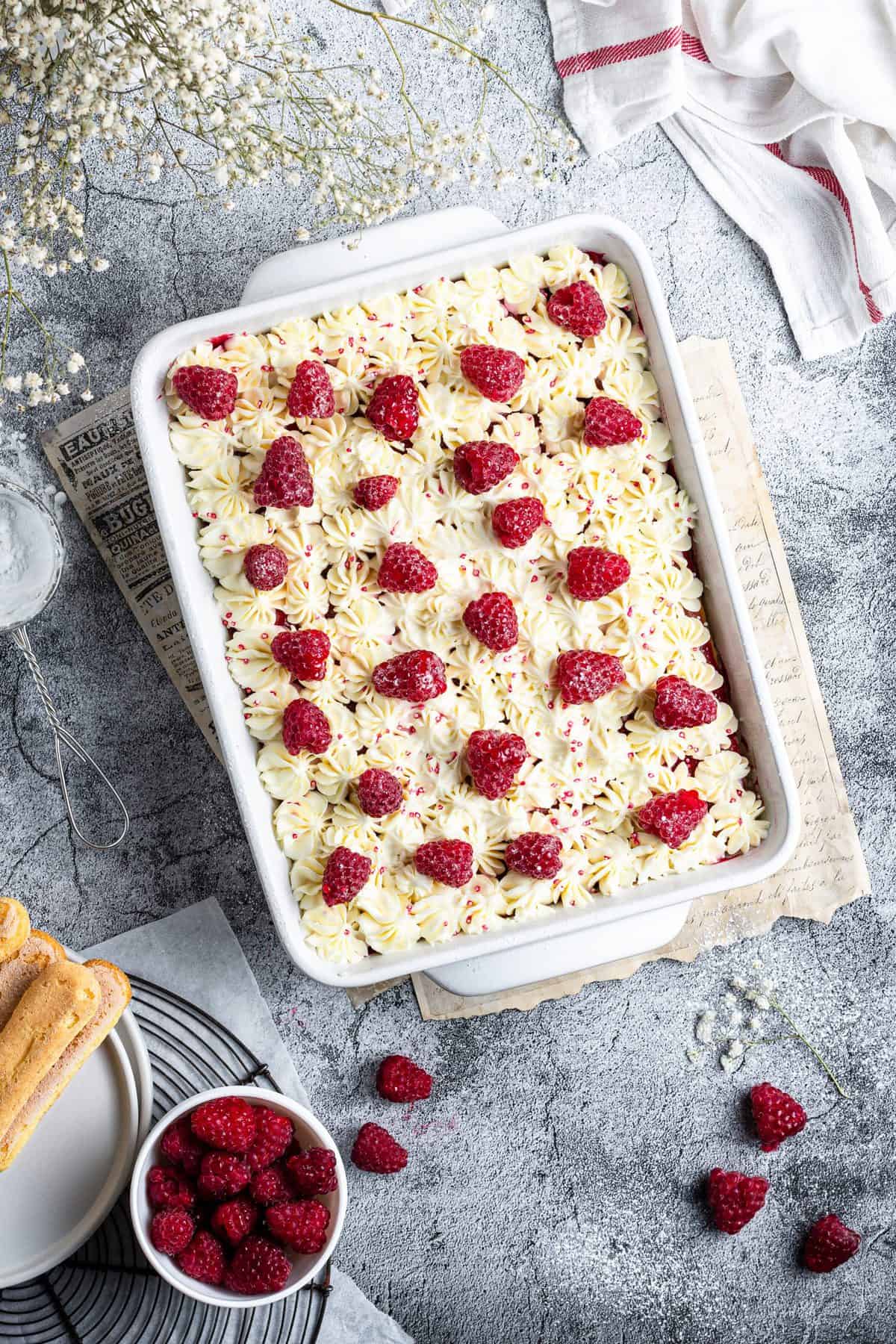 overhead shot of raspberry amaretto tiramisu on metal background