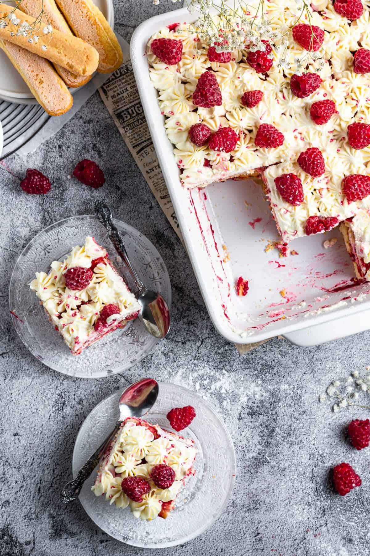 up close photo of slices of tiramisu with raspberries on top
