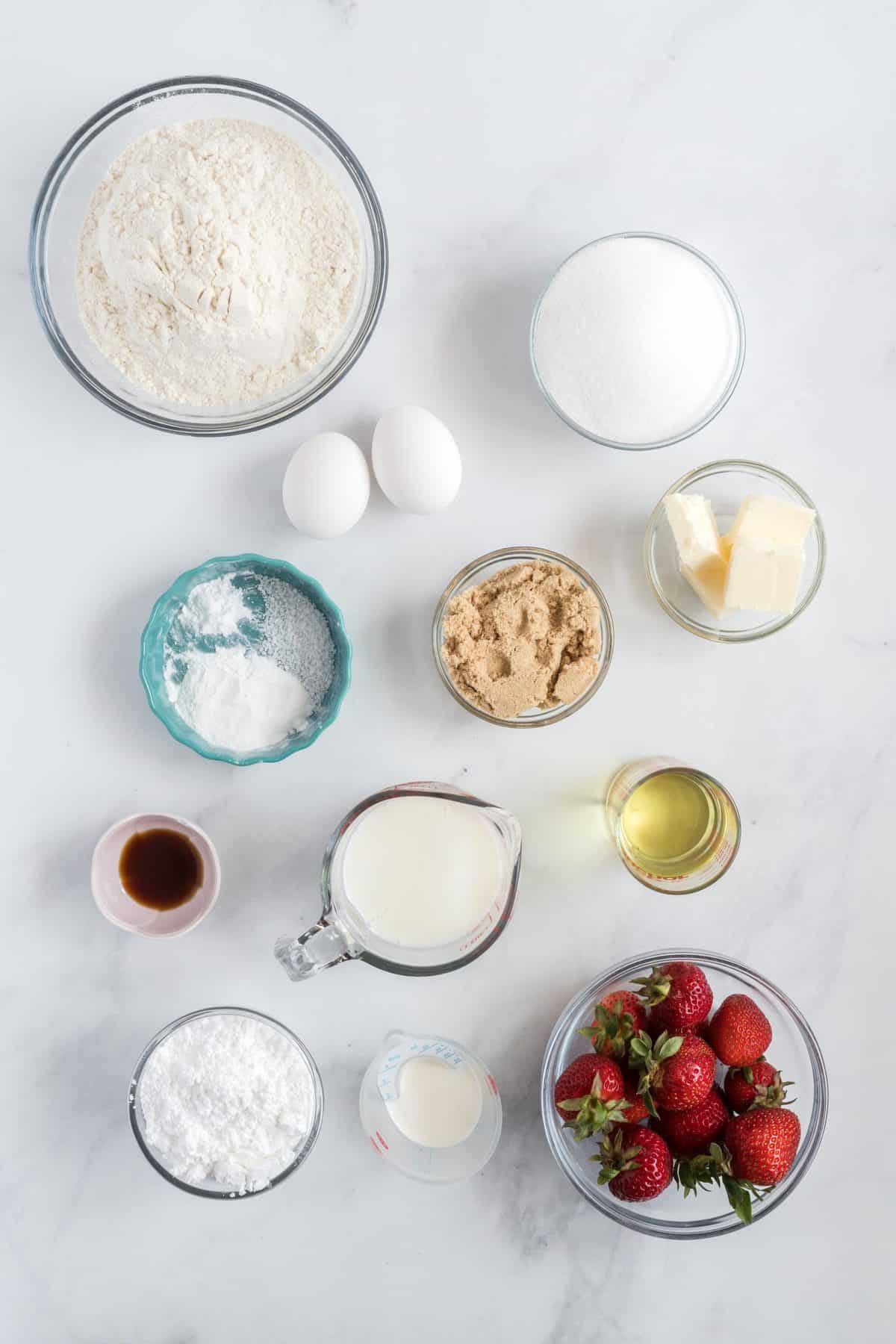 All of the ingredients in small glass bowls laid out on a white background. 