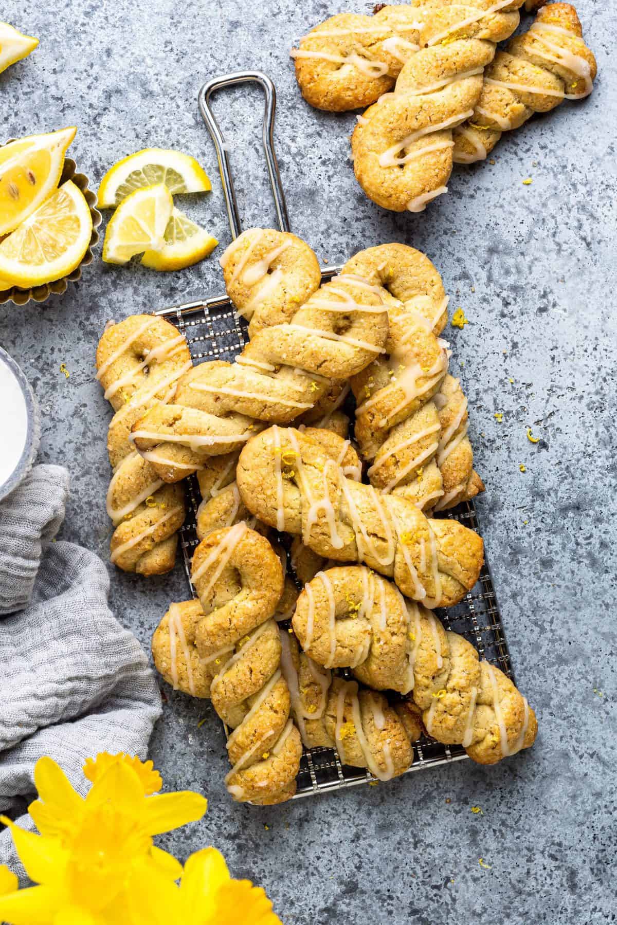 Lemon twist cookies on a vintage cooling rack and sliced of lemon on the side. 