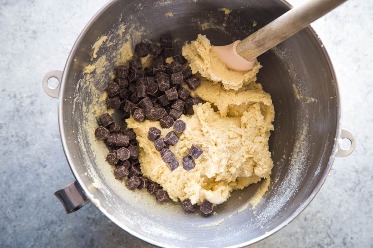 Adding the chocolate chips to the batter to make the cookies.