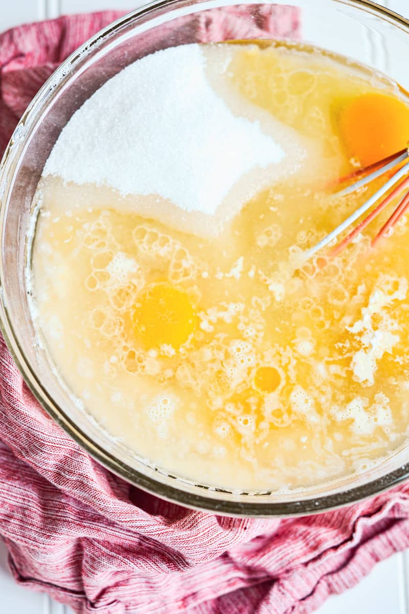 Whisking together the eggs and sugar in a large glass bowl. 