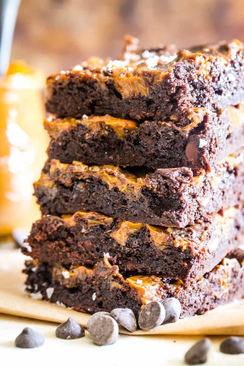 Up close photo of 5 stacked caramel swirled brownies. 
