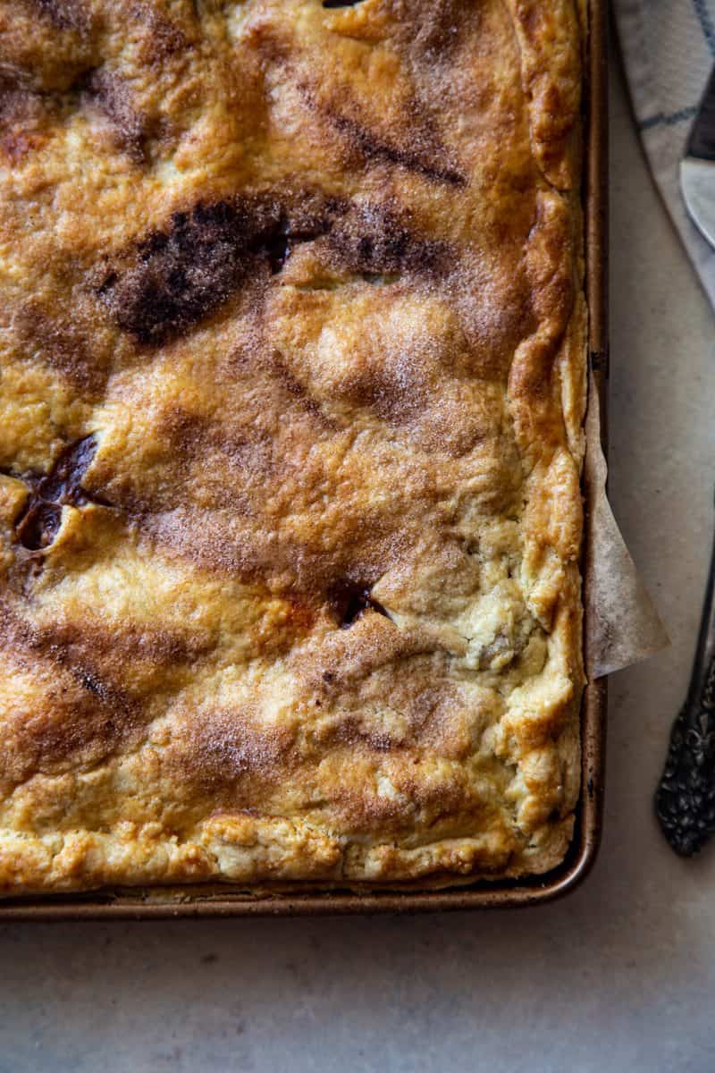 overhead shot of baked apple slab pie with golden crust. 