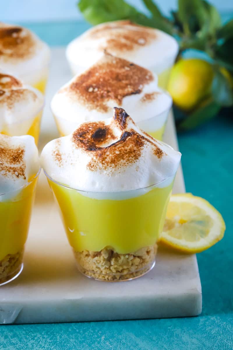 up close photo of a layered lemon pudding cup with toasted meringue. 