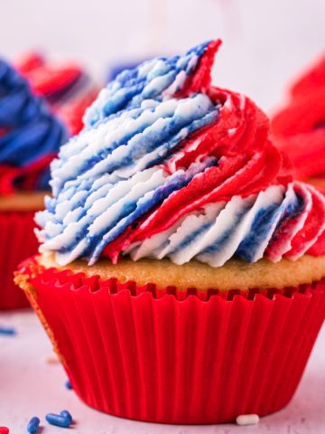 Tie Dye red white and blue frosted cupcakes in red liners.