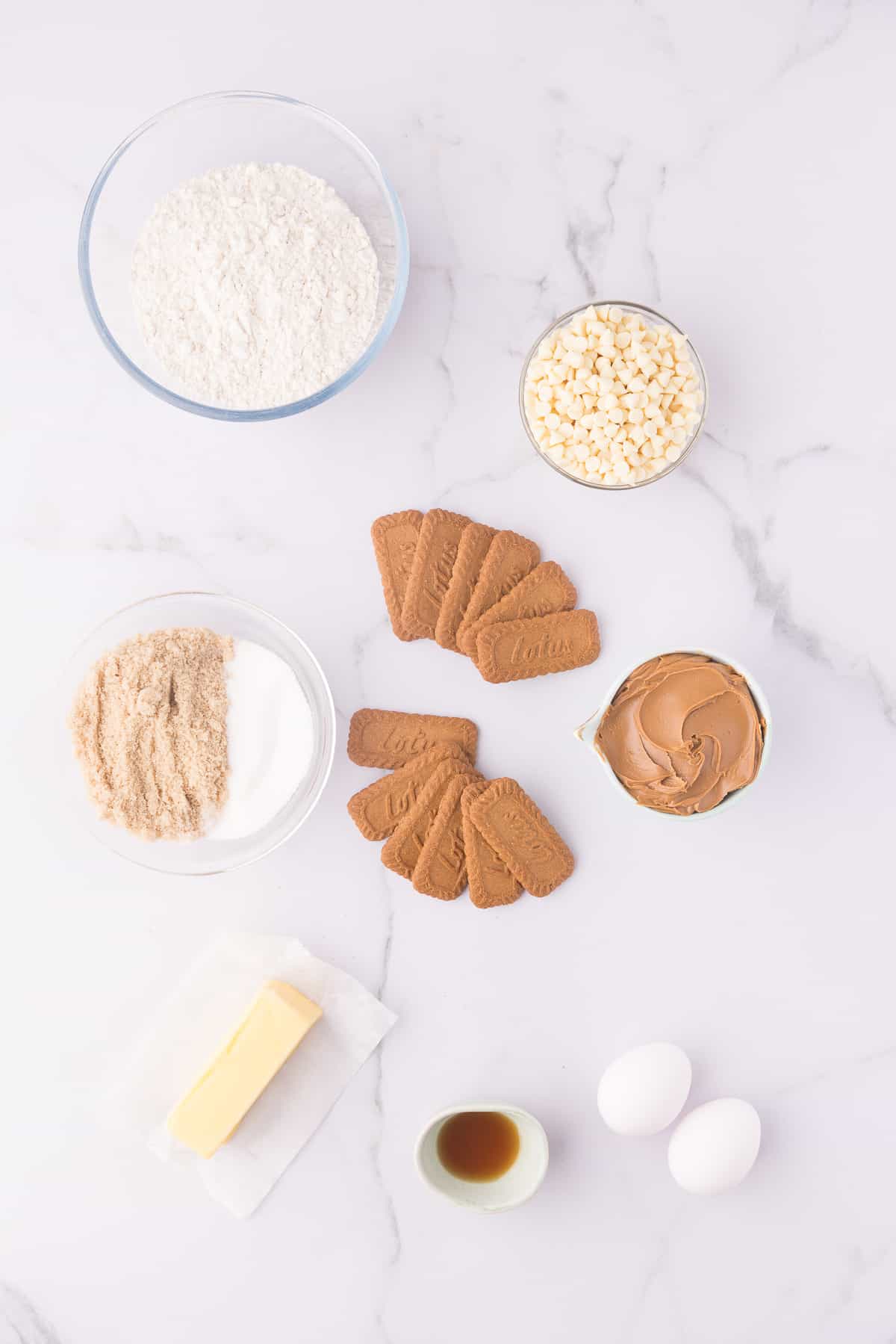 Ingredients to make biscoff blondies in small bowl on white background. 
