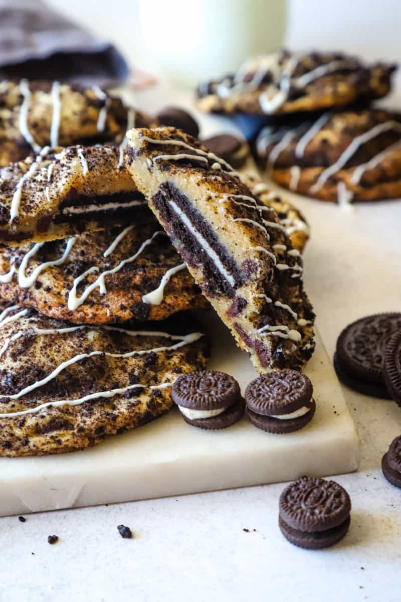 Cookies on a marble cutting board with mini Oreos around them. 