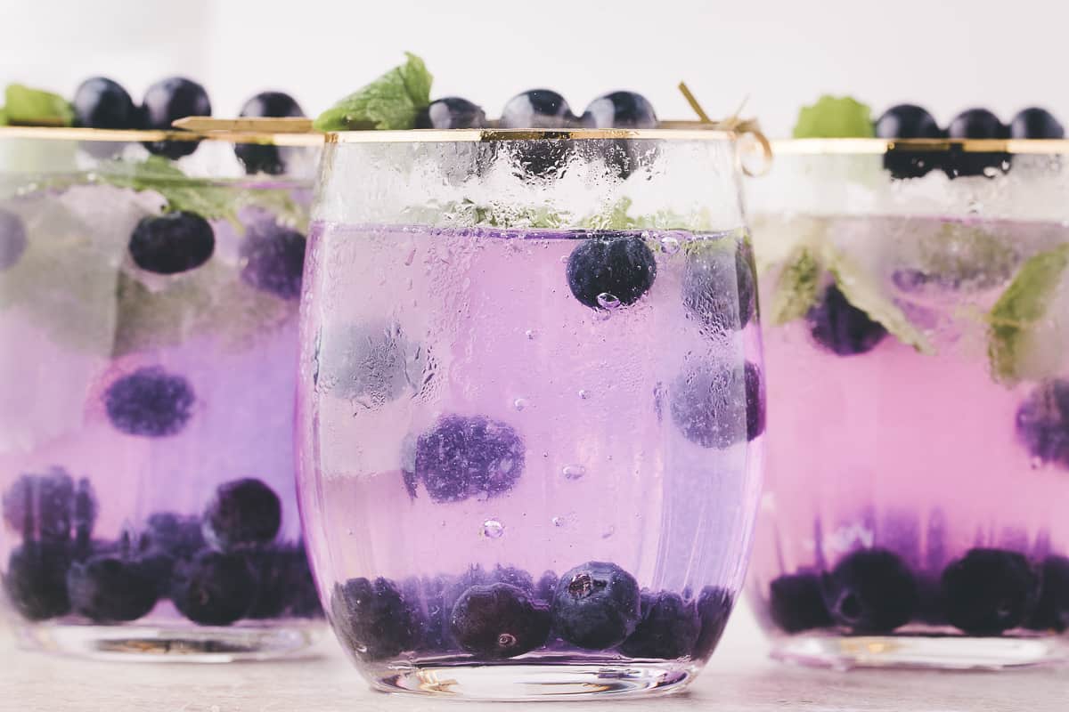 The cocktails with blueberries floating around the glass.