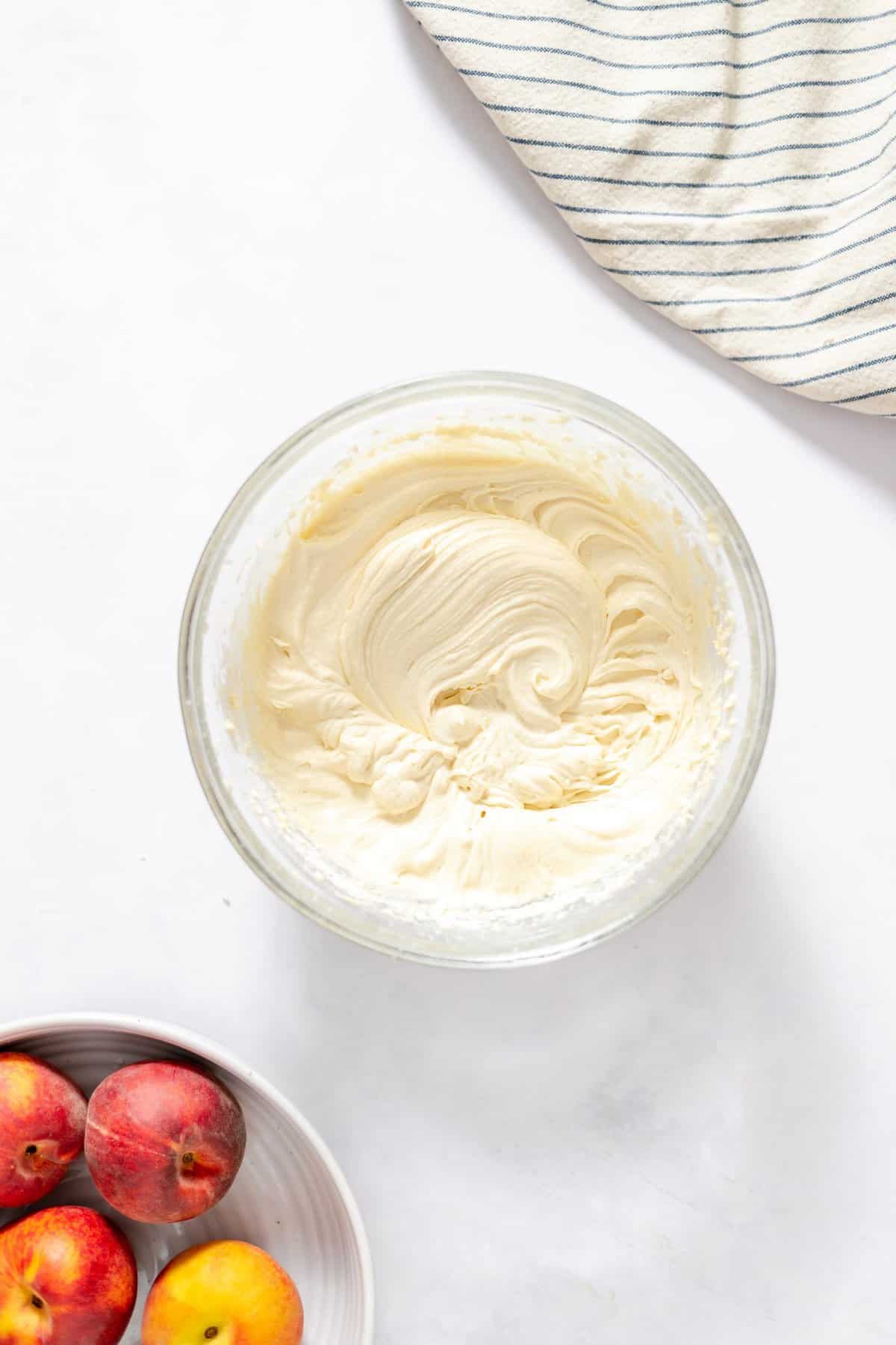 glass bowl on white background filled with cake batter.