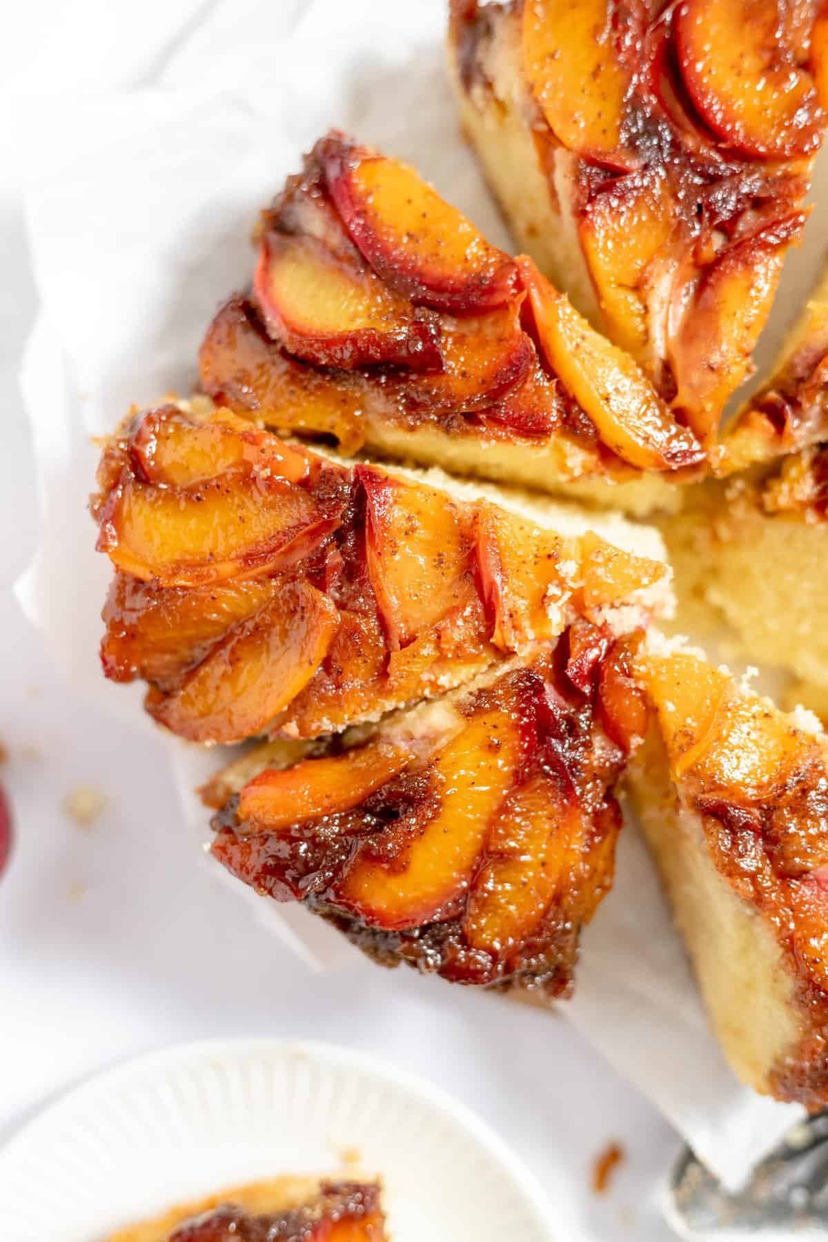 Close up shot of sliced cake on white background.