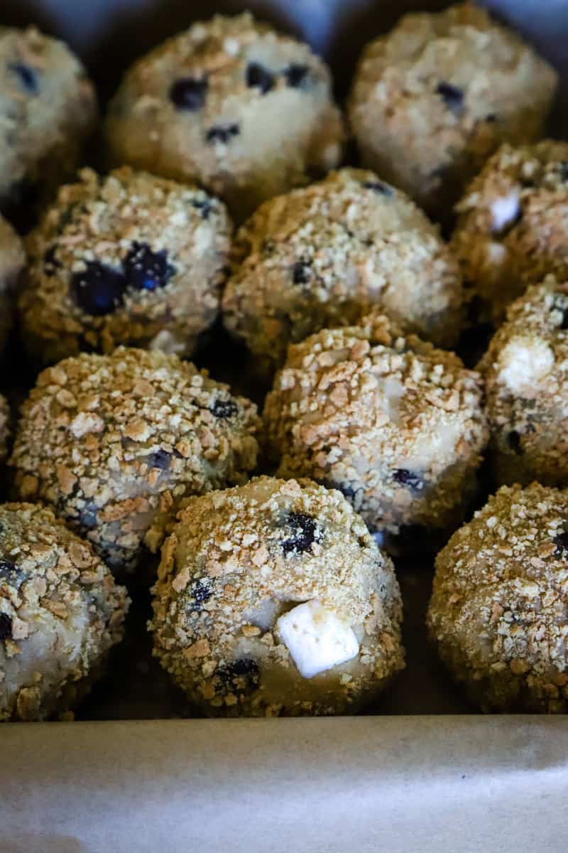 Photo of the cookie dough balls rolled In graham cracker crumbs. 