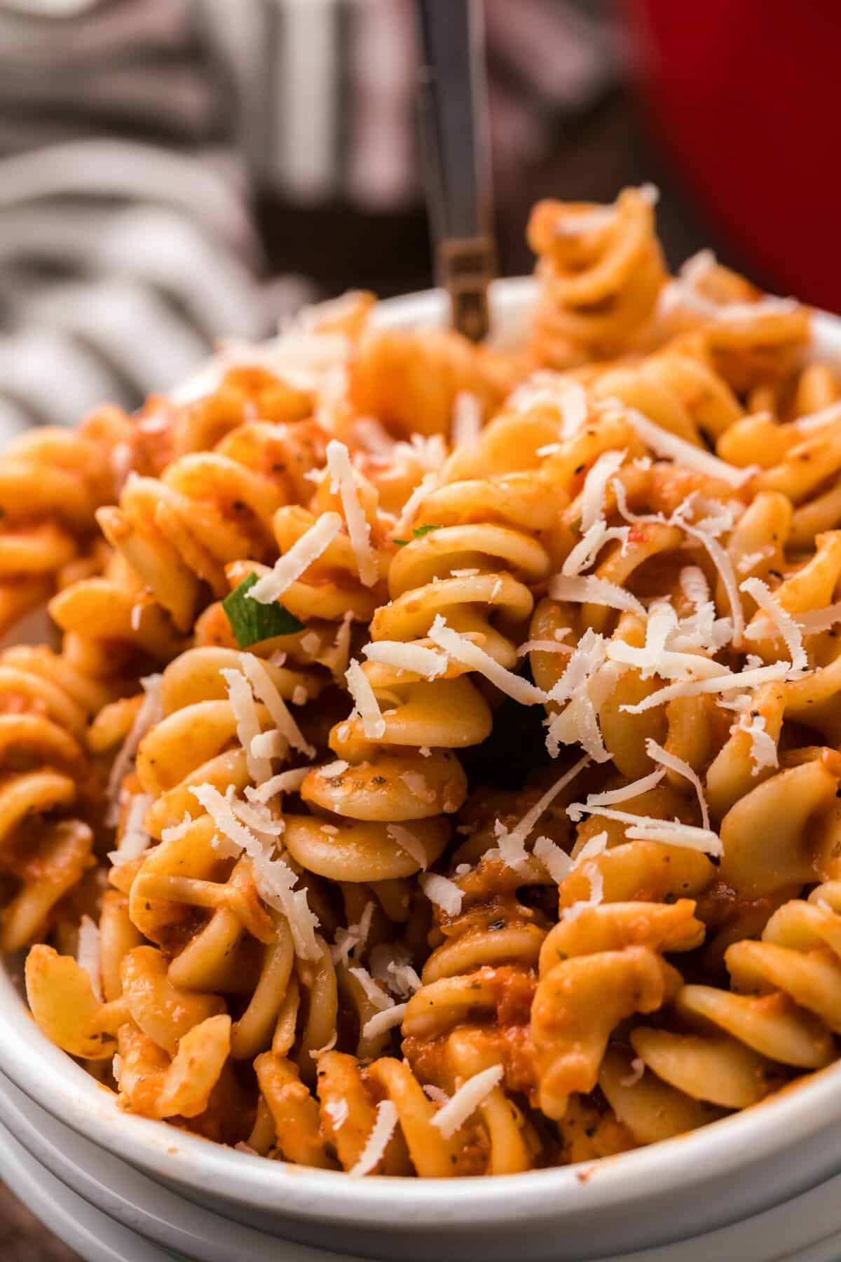 up close photo of the spicy fusilli pasta in a white bowl.