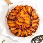 peach upside down cake on wood cutting board.