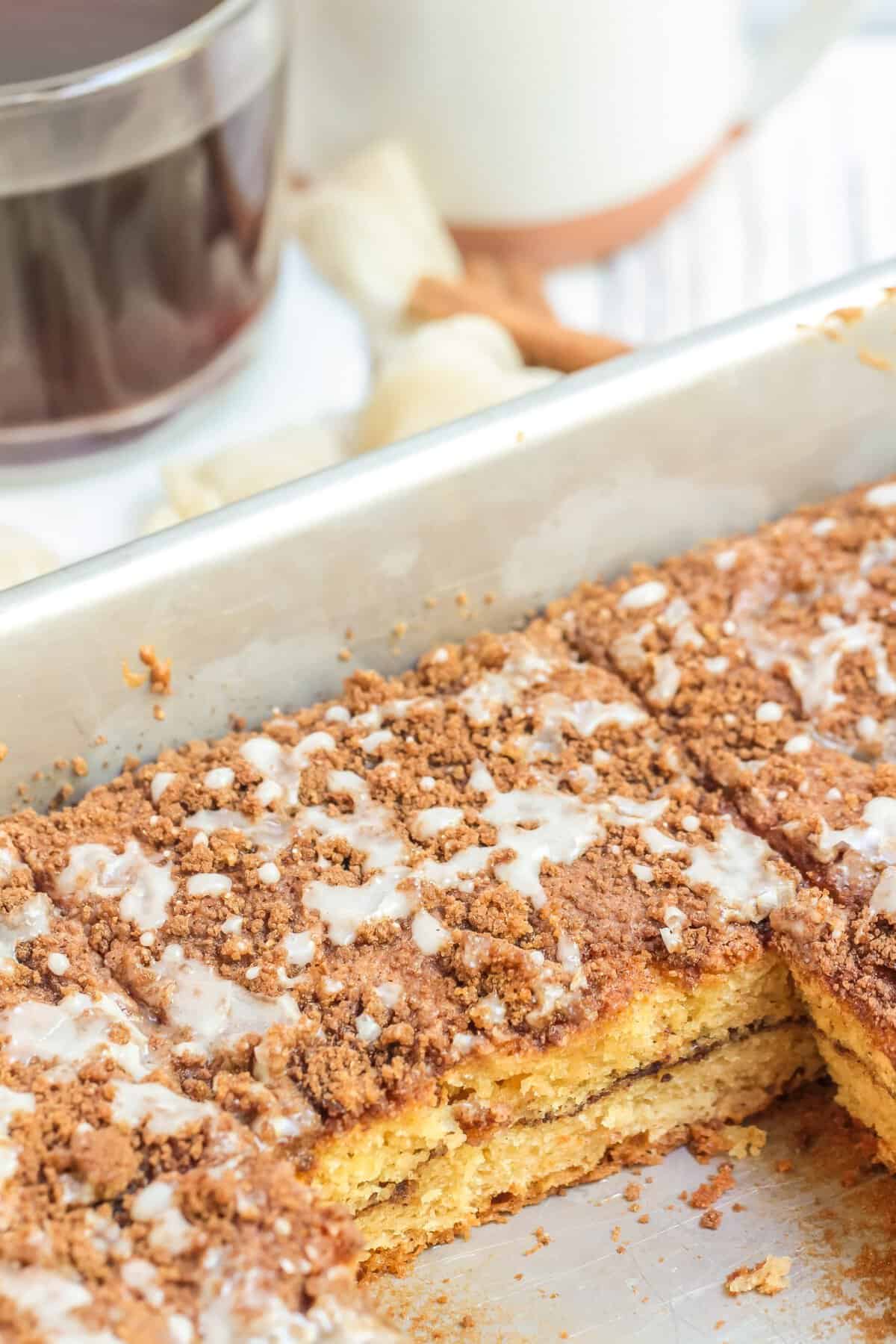 Metal pan with coffee cake slices and one slice removed. 