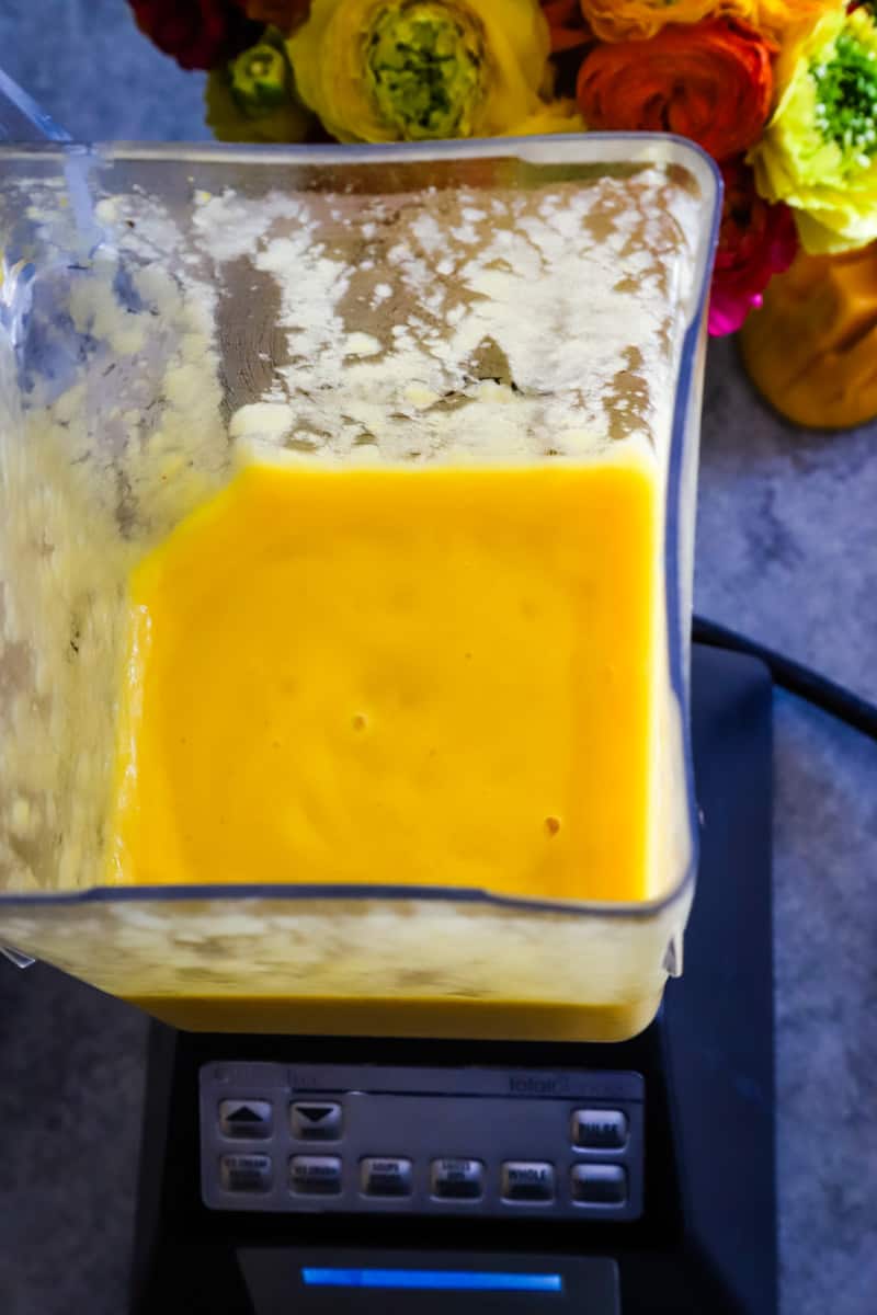 Blender with a smooth mango margarita inside. 