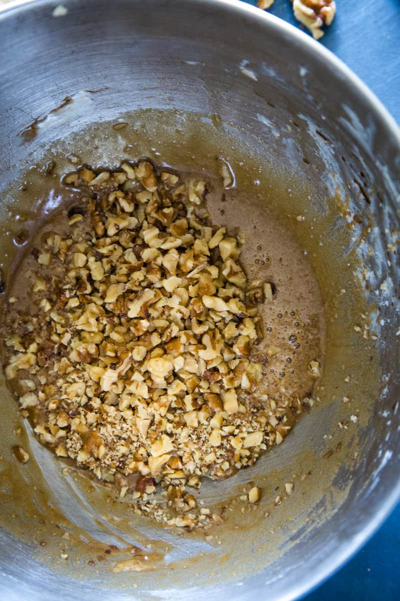 Combining the chopped walnuts with the brown sugar filling in large metal bowl. 