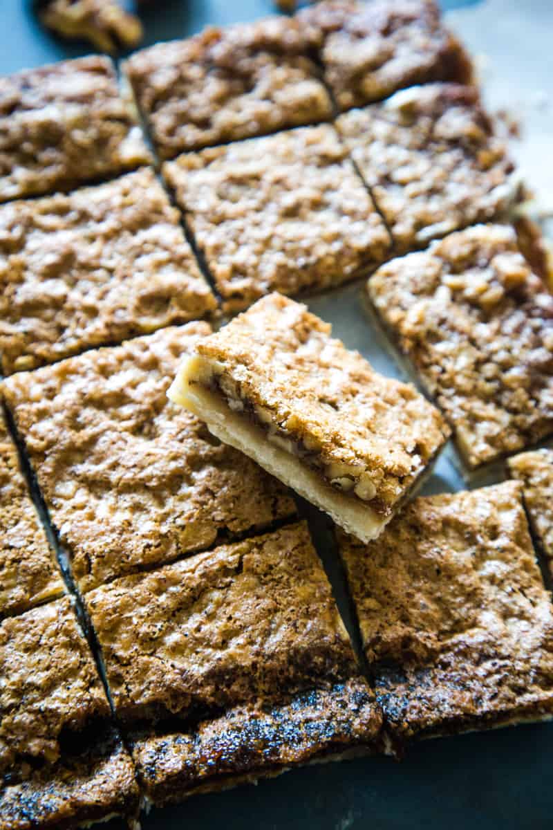 Walnut brown sugar bars cut into squares with middle square on its side to show center. 