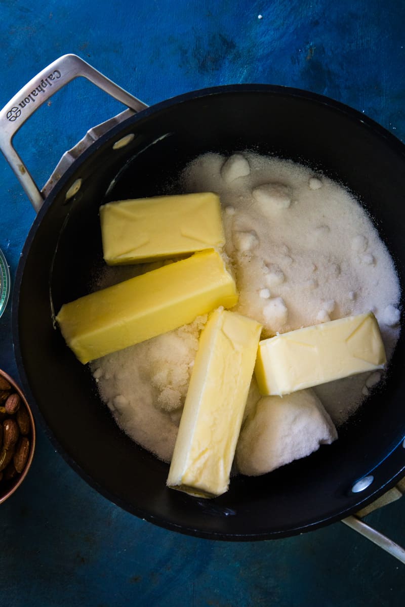 Adding the butter, sugar, and water to a large saucepan getting ready to cook. 