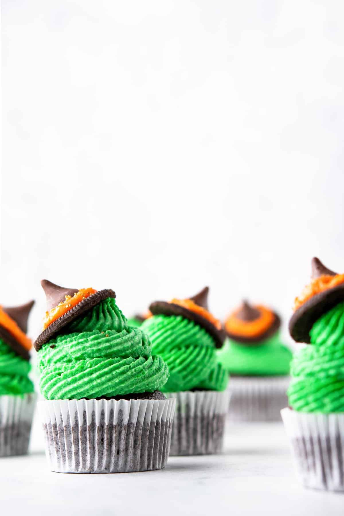 Witch hat cupcakes on bright white background and foreground. 