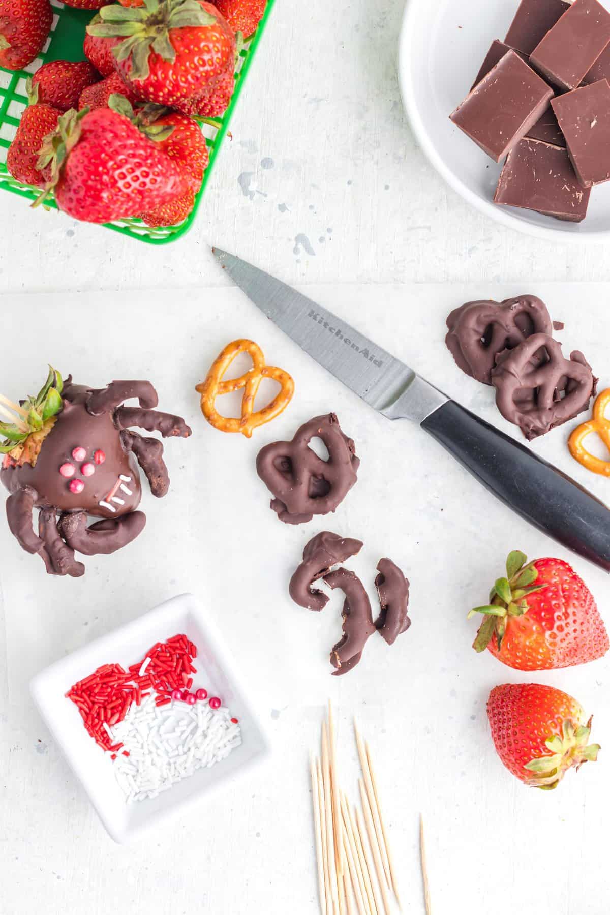 Cutting the chocolate dipped pretzel into little pieces for the legs. 