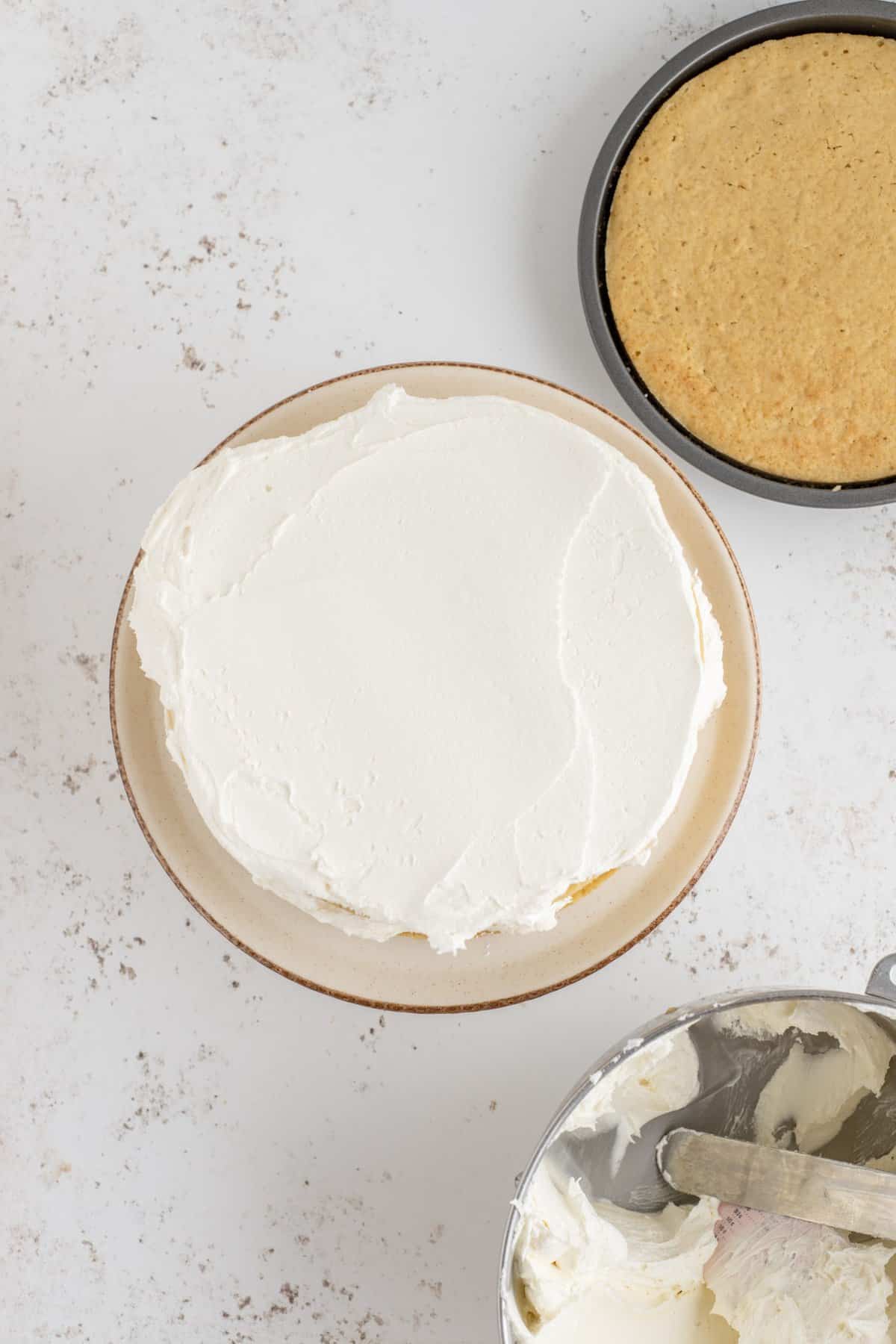 Topping the cake layer with a layer of the maple frosting. 