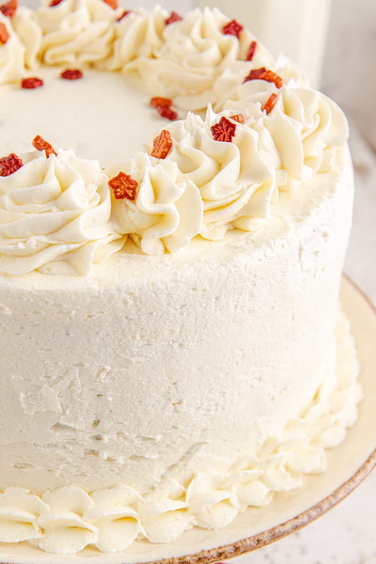 Up close shot of the frosted maple cake with red sprinkles. 