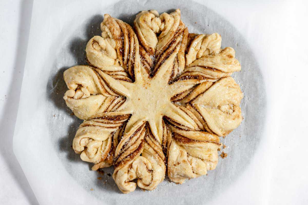 The completed cut and twisted cinnamon star bread after its second rise. 