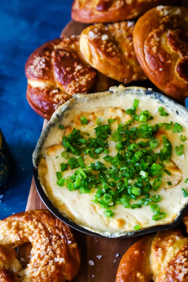 Up close photo of the beer cheese dip with pretzels around it. 