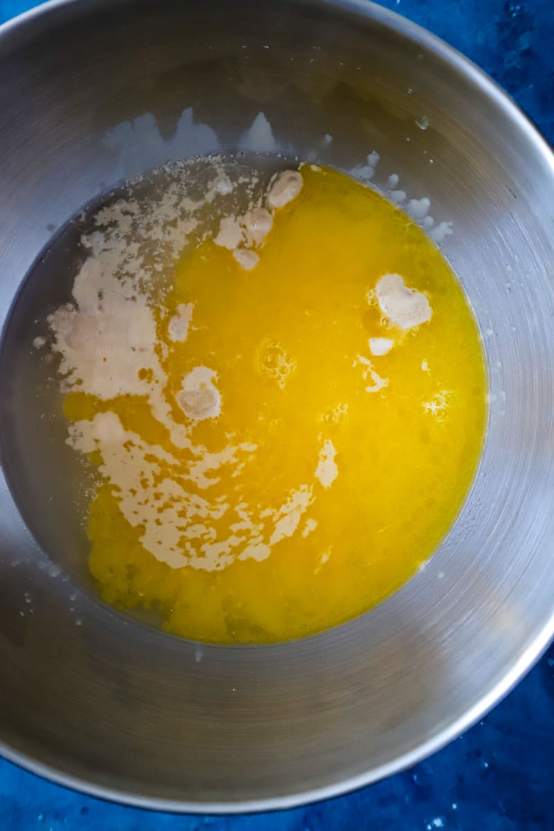 Adding the butter and honey to the yeast mixture in large metal bowl. 