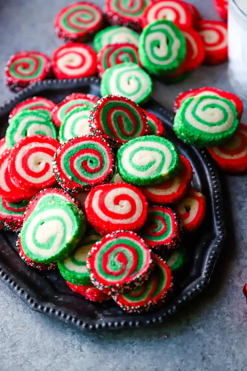 Metal tray of different colored pinwheel cookies. 