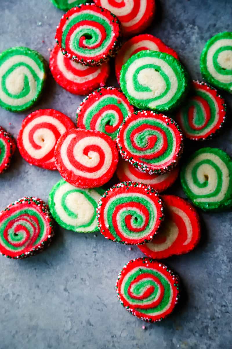 Overhead shot of pinwheel cookies stacked on each other on metal background. 