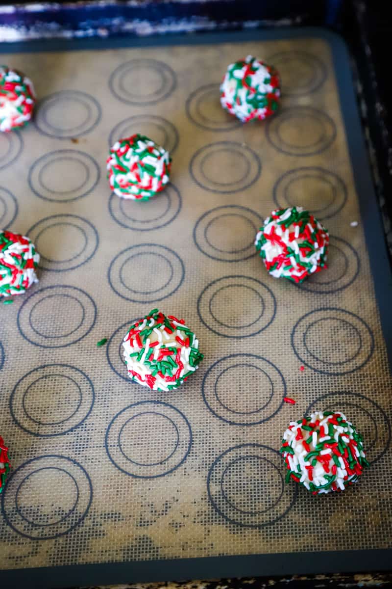 The sprinkle rolled dough balls on a silat lined cookie sheet. 