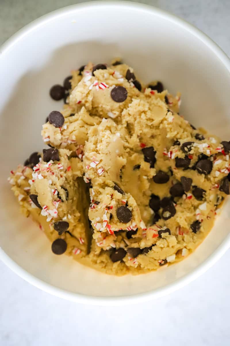 White bowl with chocolate chip and peppermint cookie dough. 