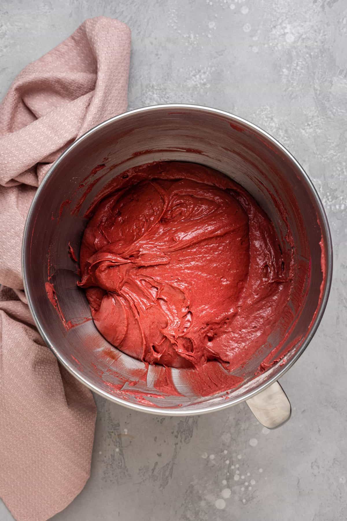The finished red velvet cake batter in metal mixing bowl. 