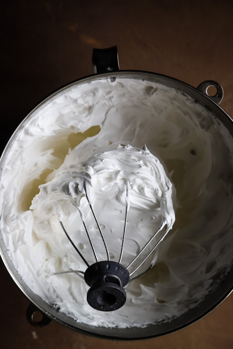 Using the whisk attachment on mixer to whip egg white and sugar until fluffy. 