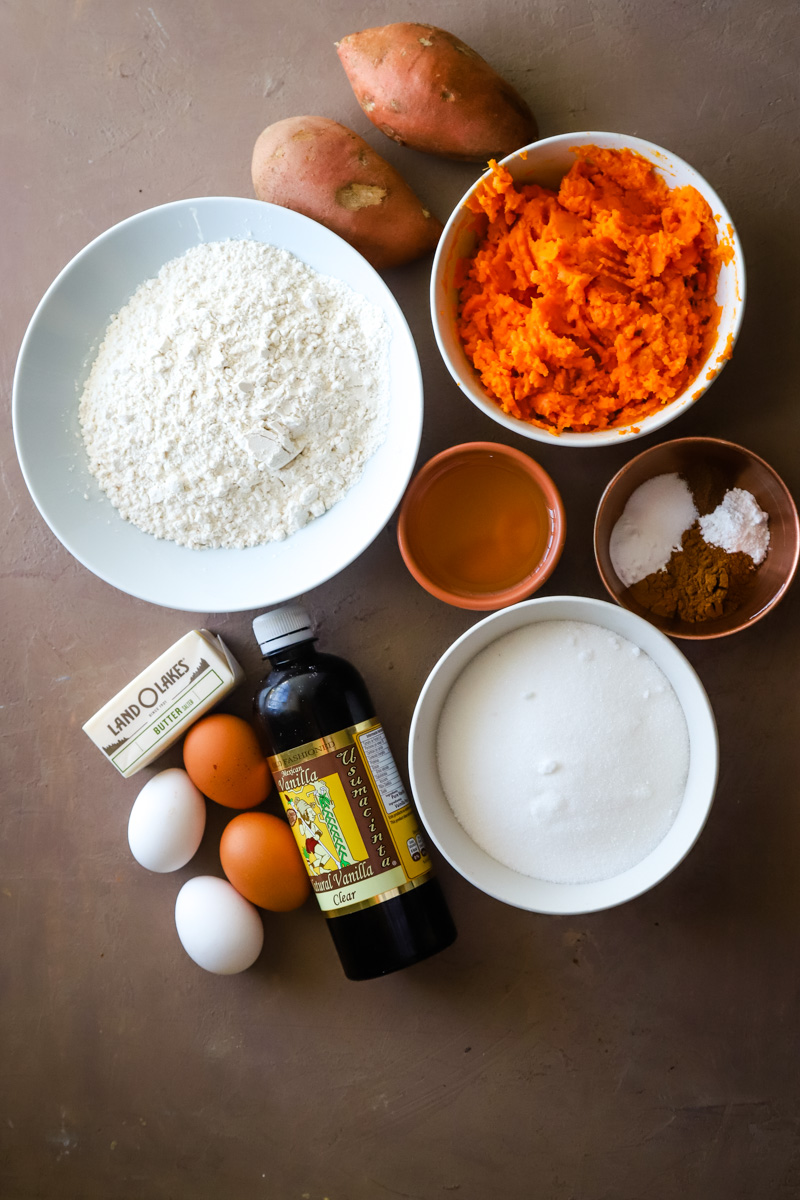 Ingredients to make the sweet potato cake layers on a brown background. 