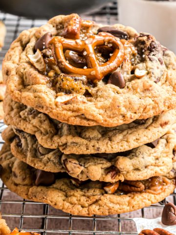 Cookies stacked on wire rack with top cookie having a whole pretzel baked in.