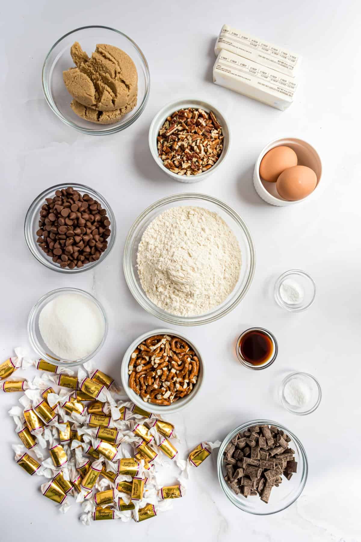 Overhead shot of ingredients in glass bowls on white background. 