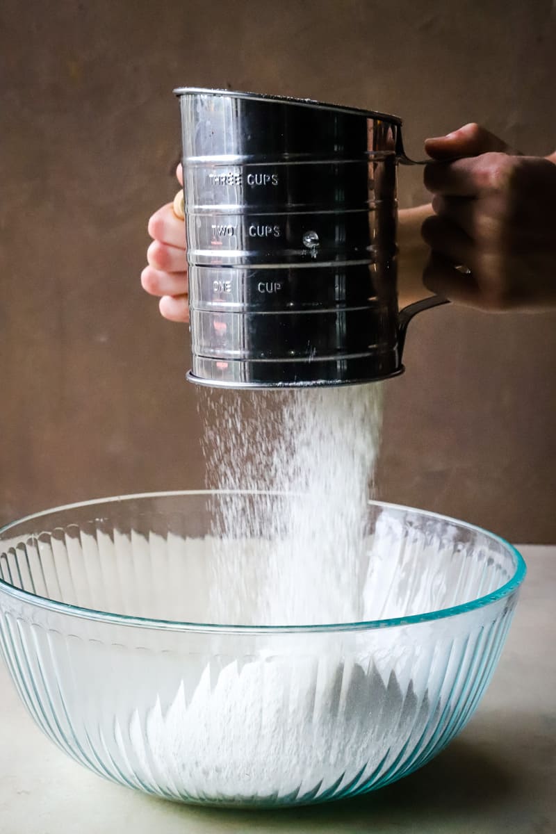 Sifting the flour into a large glass bowl to make the old fashioned pound cake. 