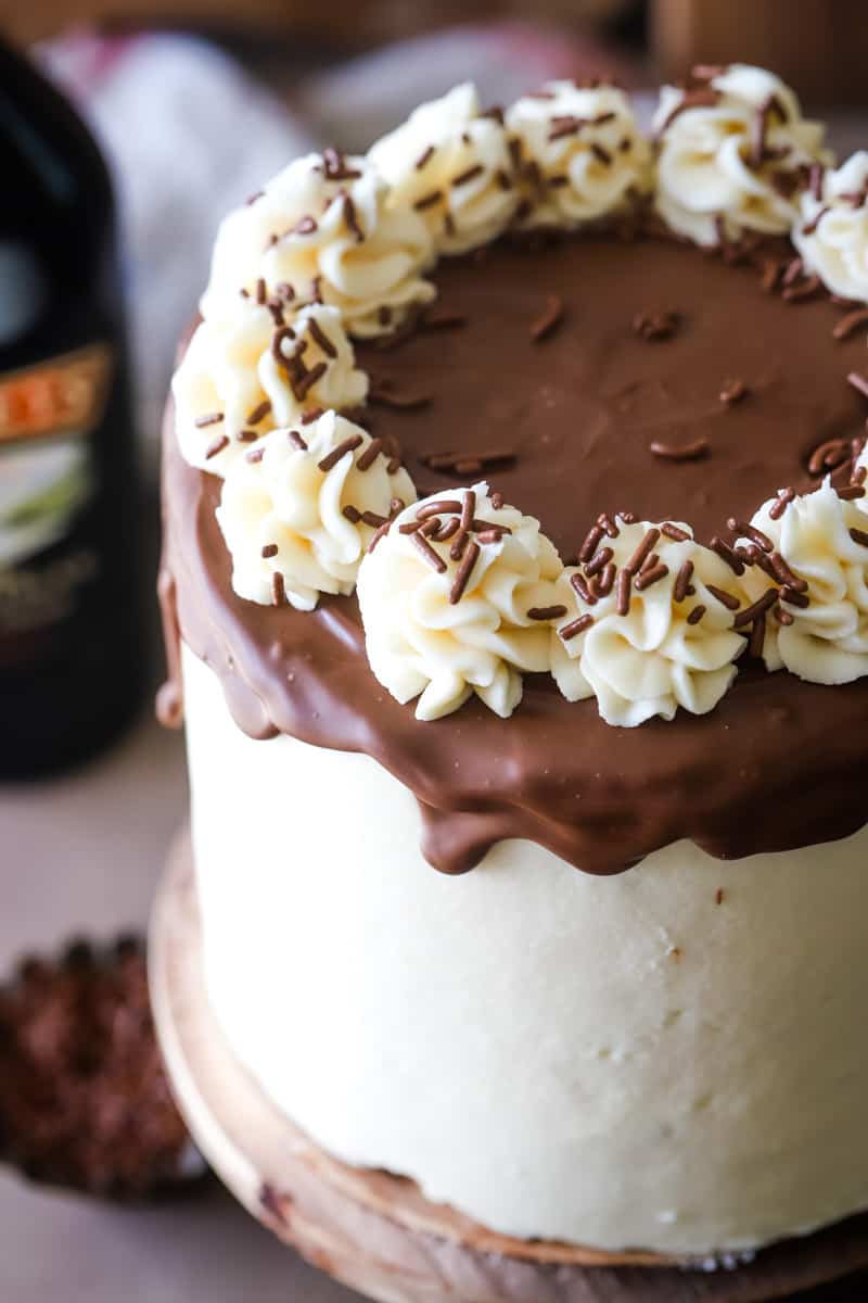 Up close shot of the cake with chocolate ganache dripping down and swirls of frosting. 