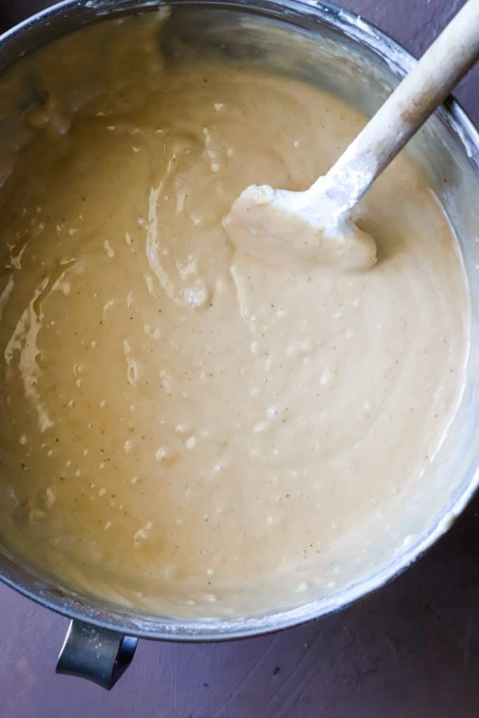 Final overhead shot of the finished cake batter in metal bowl with spatula. 