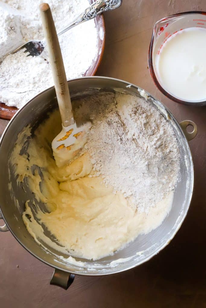 Overhead shot of metal mixing bowl with creamed butter and sugar and flour mixture. 